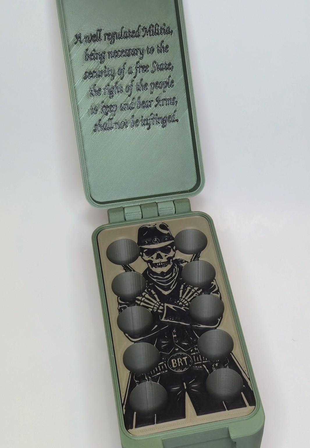 Open BRT .50 BMG showcase box showing the custom 10-round insert and interior art