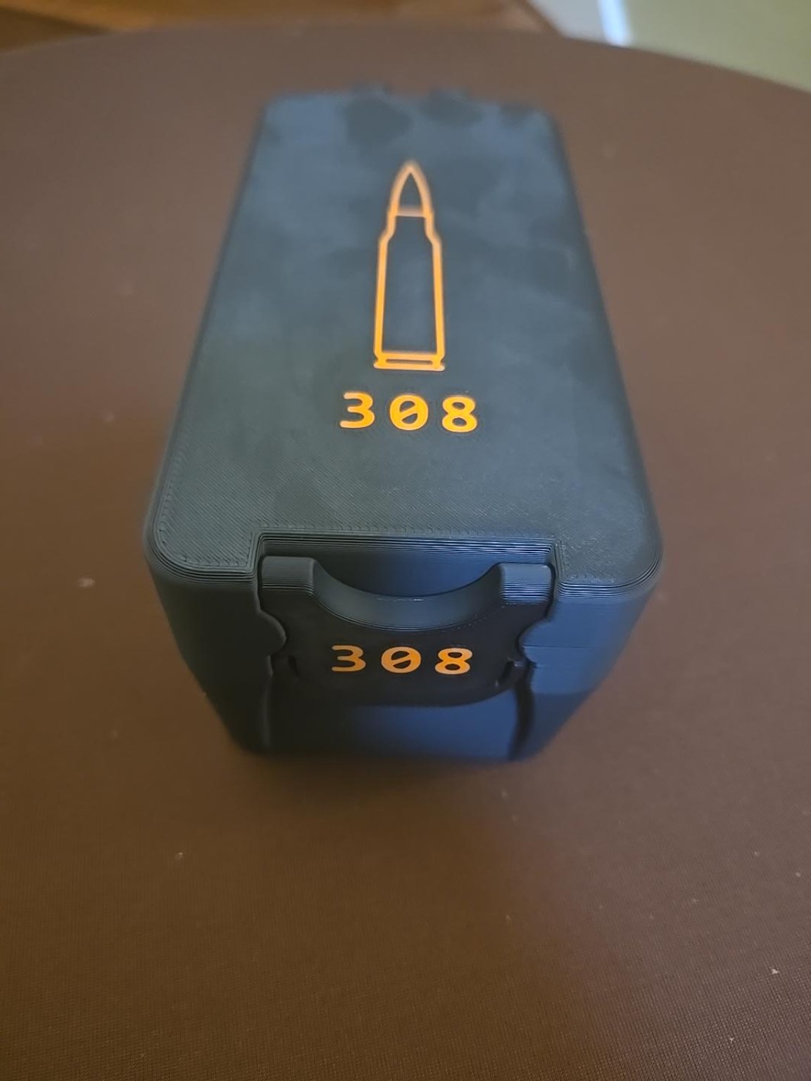 Black BRT 308 Winchester ammunition box with orange caliber markings