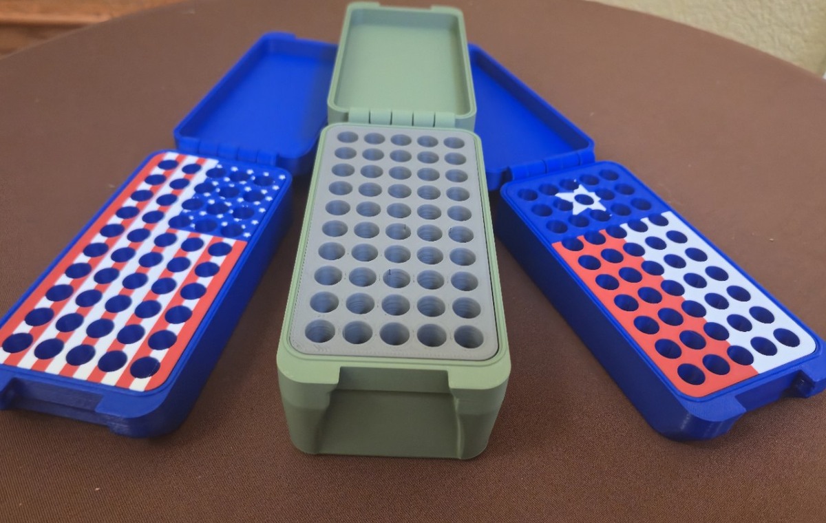 Open custom Bench Rest Tools ammunition boxes showing fitted American flag, camouflage, and Texas flag inserts